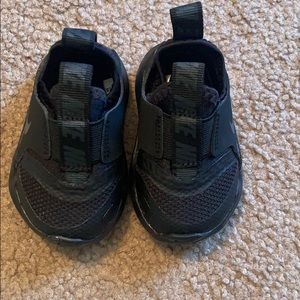 Solid black Nike tennis shoes